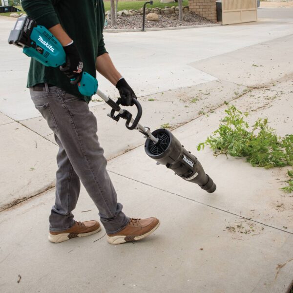Makita UB401MP Action Shot (blowing leaves 2) UB401MP Blower Couple Shaft Attachment product image